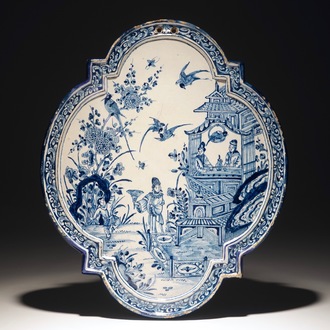 A Dutch Delft blue and white chinoiserie plaque with figures near a pagoda, 18th C.