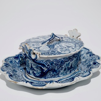 A Dutch Delft blue and white butter tub on stand, 18th C.