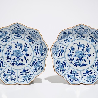 A pair of Dutch Delft blue and white lotus-shaped plates, 18th C.