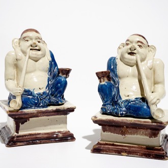 A pair of German faience models of Buddhas in Delft style, 1st half 18th C.