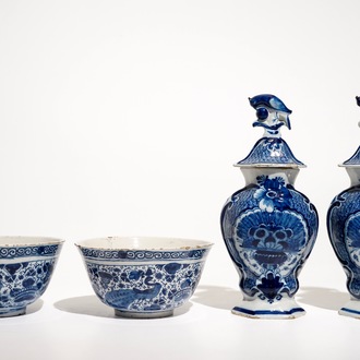 A pair of Dutch Delft blue and white bowls and a pair of vases and covers, 18th C.