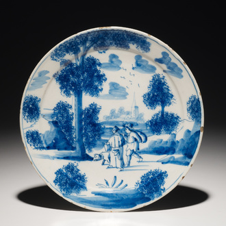 A Dutch Delft blue and white plate with figures in a landscape, 1st half 18th C.