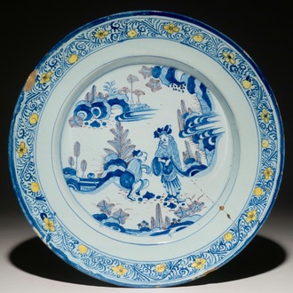 A large Dutch Delft chinoiserie dish in blue and manganese with a yellow border, 2nd half 17th C.