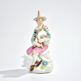 A Meissen porcelain Commedia del'Arte figure of Harlequin playing the bagpipe, 18th C.