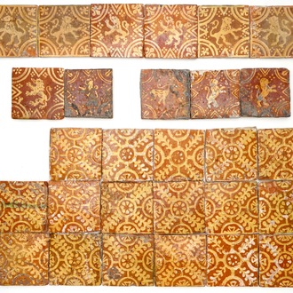 A group of 28 slip-decorated Flemish medieval style tiles with rampant lions and ornamental designs, 18th C.