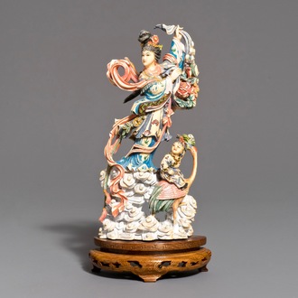 A Chinese polychrome carved ivory figure of Magu on wooden base, 1st half 20th C.