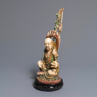 A large polychrome Chinese ivory group of a sage with a mythical beast, 19th C.
