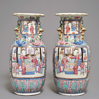 A pair of Chinese famille rose vases with figures in an interior, 19th C.