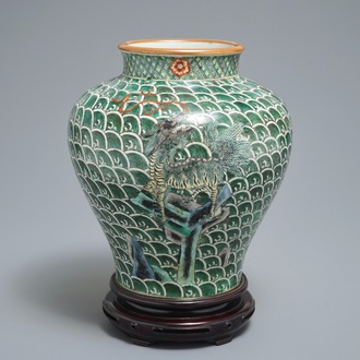 A Chinese famille verte vase with mythical beasts on a ground of waves, 19th C.