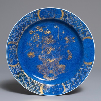A Chinese powder blue and gilt dish with a flowervase, Kangxi