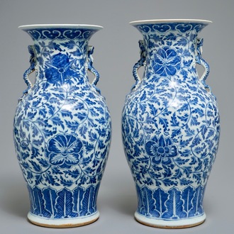 A pair of Chinese blue and white flower scroll vases, 19th C.