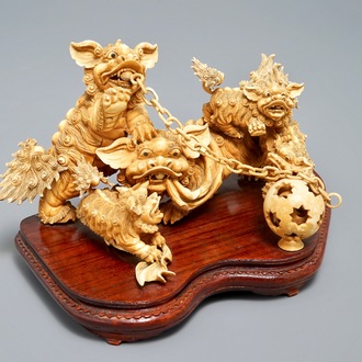 A Chinese carved ivory group of Buddhist lions playing with a ball, 19/20th C.