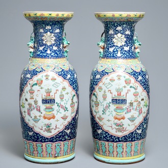 A pair of Chinese famille rose blue-ground vases, 19th C.