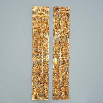 A pair of Chinese carved, lacquered and gilt wood panels with figurative designs, 19th C.
