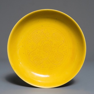 A Chinese monochrome yellow dish with incised lotus design, Kangxi mark, 20th C.