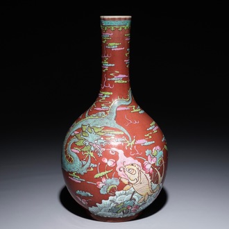 A Chinese oxblood-glazed bottle vase with overglaze design of a dragon and a carp, 19th C.