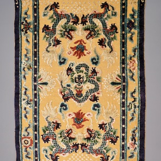 A Chinese silk and gilt-thread 'five dragon' carpet with inscription, 19th C.