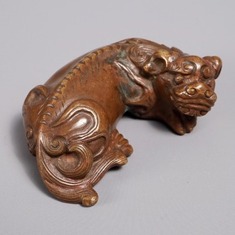 A Chinese bronze scroll or paper weight shaped as a Buddhist lion or Shishi, 17/18th C.