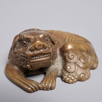 A Chinese bronze scroll or paper weight shaped as a Buddhist lion or Shishi, 17/18th C.