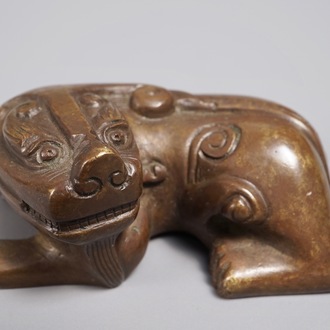 A Chinese bronze scroll or paper weight shaped as a Buddhist lion or Shishi, 18/19th C.