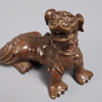 A Chinese bronze scroll or paper weight shaped as a Buddhist lion or Shishi, 18/19th C.