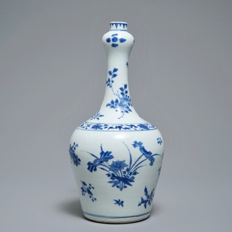 A Chinese blue and white bottle vase with floral design, Transitional period