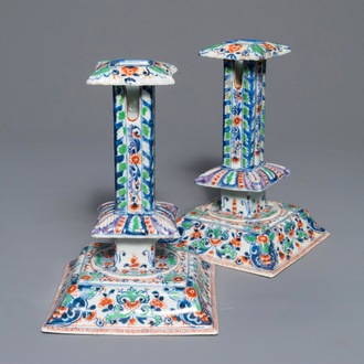 A pair of clobbered Chinese blue and white candlesticks, Kangxi