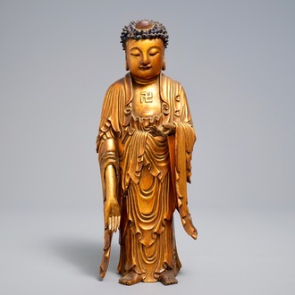 A Chinese carved gilt wood figure of Buddha standing, 18/19th C.