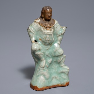 A Chinese Longquan celadon and biscuit figure of Zhenwu, Ming