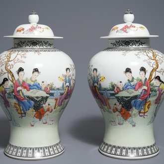 A pair of Chinese famille rose vases and covers, Qianlong mark, 20th C.