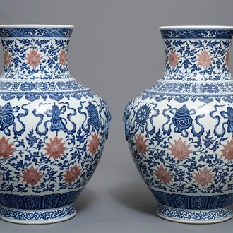 A pair of Chinese blue, white and iron red hu vases with taoist symbols, Qianlong mark, 20th C.