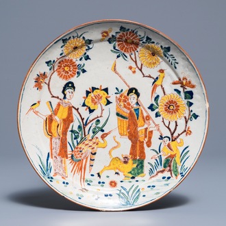 A polychrome Dutch Delft chinoiserie plate with figures around a tiger, 18th C.