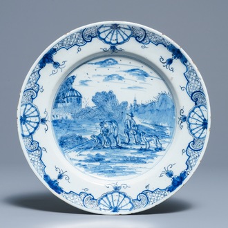 A Dutch Delft blue and white dish with figures in a landscape, 18th C.