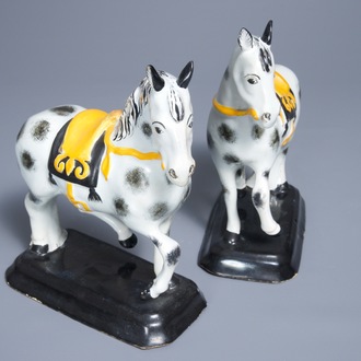 A pair of polychrome Dutch Delft black and yellow models of circus horses, 19th C.