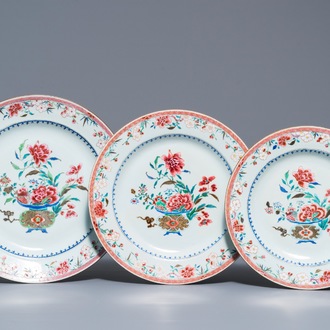 Three Chinese famille rose chargers with flower vases, Qianlong