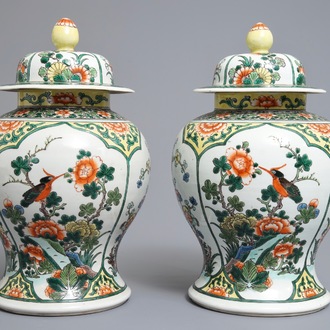 A pair of Chinese famille verte vases and covers with birds and flowers, 19th C.