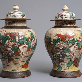 A pair of Chinese Nanking famille rose vases and covers with warriors, 19/20th C.