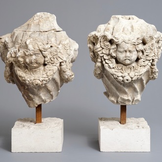 A pair of architectural stone ornaments with cherub's heads and garlands, 18th C.