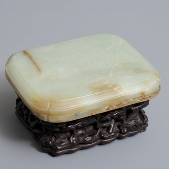 A Chinese celadon and russet jade box and cover on wooden stand, Ming/Qing