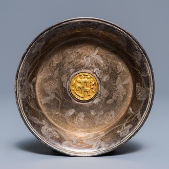 A Sino-Tibetan engraved silver dish with gilt central medallion, 19/20th C.