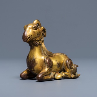 A Chinese gilt bronze scroll or paper weight in the form of a ram, 19/20th C.