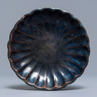 A Chinese Shiwan flambé-glazed 'chrysanthemum' dish, impressed mark, 18/19th C.