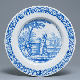 A large Dutch Delft blue and white dish with Jesus and the Samaritan woman, last quarter 17th C.