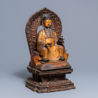 A large Chinese gilt-laquered and inlaid bronze figure of Zhenwu on gilt wooden base, Ming