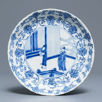 A Chinese blue and white moulded plate with figures on a terrace, Kangxi mark and of the period