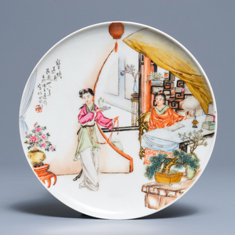 A Chinese famille rose plate with figures in an interior, Republic, 20th C.