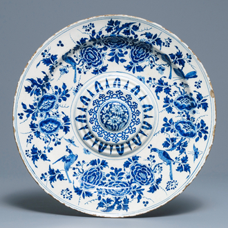 A large Dutch Delft blue and white salad dish with birds among flowers, late 17th C.