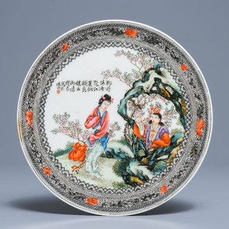 Une assiette en porcelaine de Chine famille rose à décor de figures dans un jardin, République, 20ème