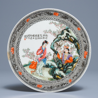 A Chinese famille rose plate with figures in a garden, Republic, 20th C.