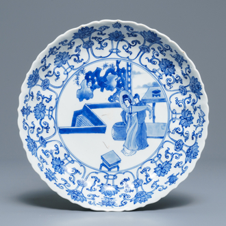 A Chinese blue and white moulded plate with figures on a terrace, Kangxi mark and of the period